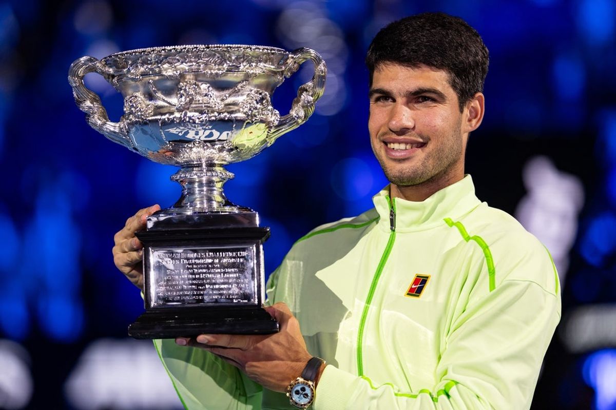 Jan 31, 2026; Melbourne, Victoria, Australia; Carlos Alcaraz of Spain with the Norman Brookes Challenge Cup after his victory over Novak Djokovic of Serbia in the final of the menís singles at the Australian Open at Rod Laver Arena in Melbourne Park. Mandatory Credit: Mike Frey-Imagn Images