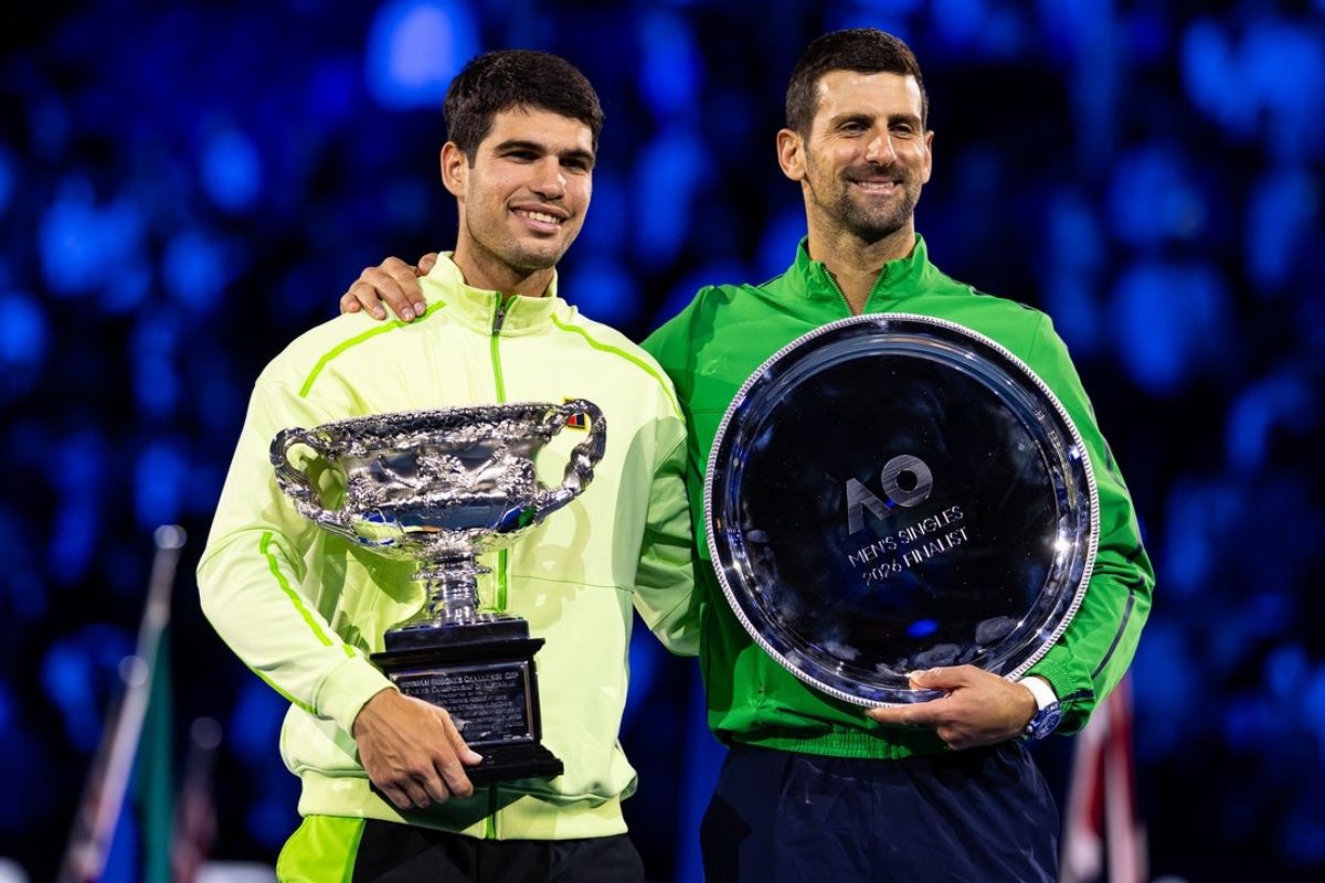Feb 01, 2026; Melbourne, Victoria, Australia; Carlos Alcaraz of Spain and Novak Djokovic of Serbia during the trophy presentation after the final of the menís singles at the Australian Open at Rod Laver Arena in Melbourne Park. Mandatory Credit: Mike Frey-Imagn Images