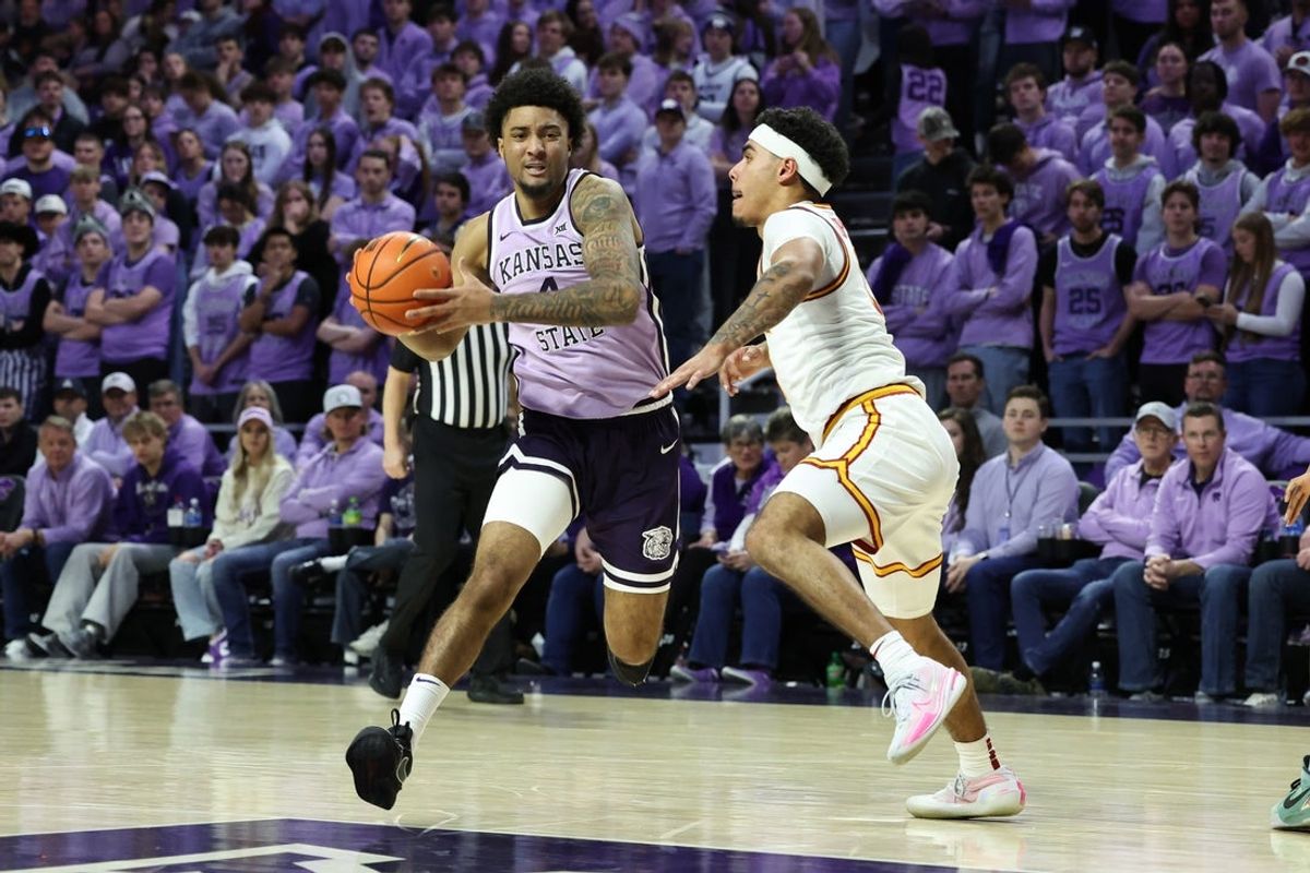 Feb 1, 2026; Manhattan, Kansas, USA; Kansas State Wildcats guard P.J. Haggerty (4) drives to the basket against Iowa State Cyclones guard Tomin Lipsey (3) during the first half at Bramlage Coliseum. Mandatory Credit: Scott Sewell-Imagn Images