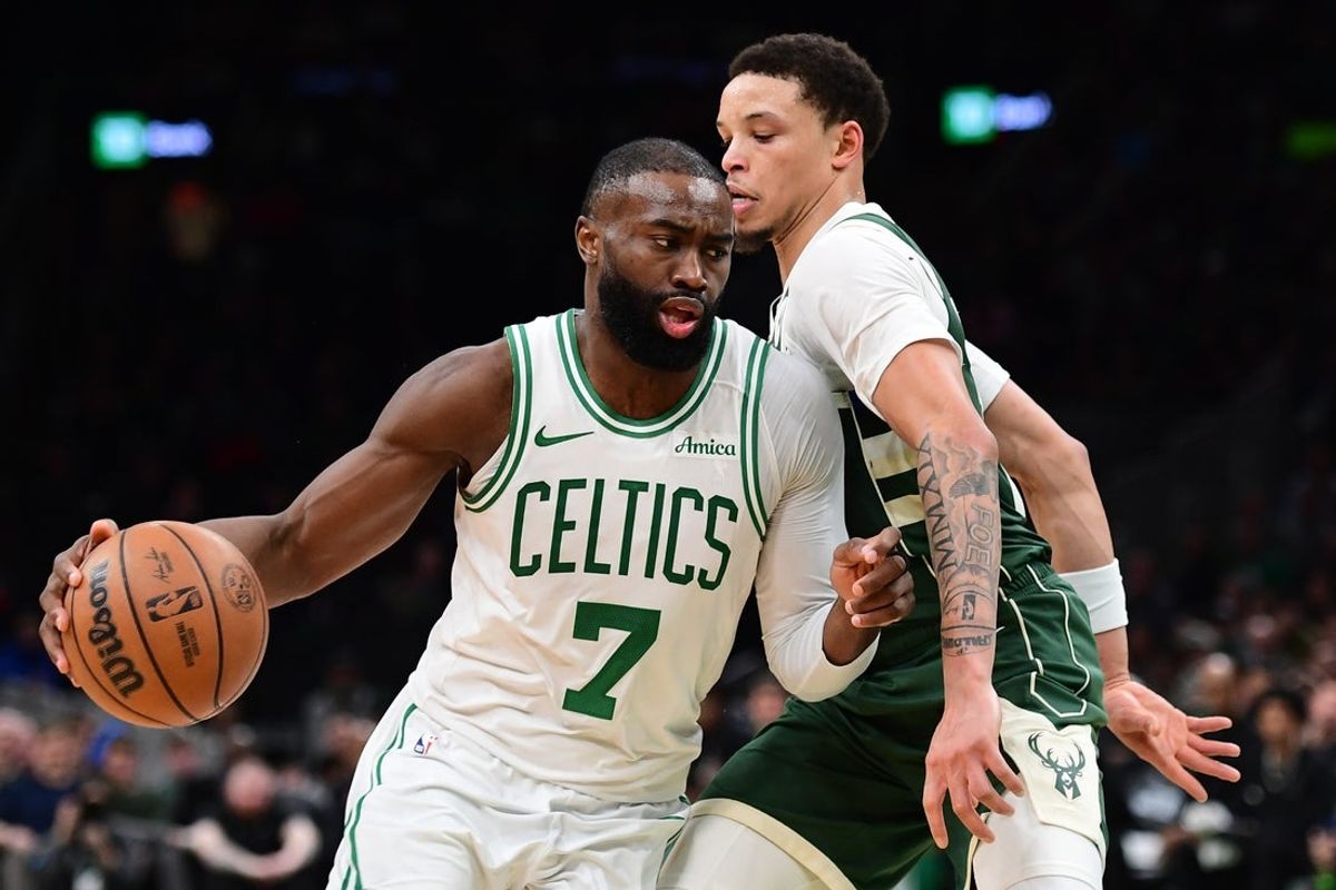 Feb 1, 2026; Boston, Massachusetts, USA; Boston Celtics guard Jaylen Brown (7) controls the ball while Milwaukee Bucks guard Ryan Rollins (13) defends during the second half at TD Garden. Mandatory Credit: Bob DeChiara-Imagn Images
