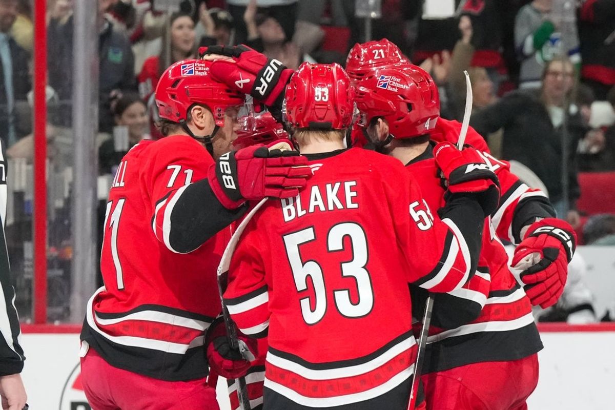 Feb 1, 2026; Raleigh, North Carolina, USA; Carolina Hurricanes defenseman Alexander Nikishin (21) is congratulated by defenseman Shayne Gostisbehere (4) right wing Jackson Blake (53) and left wing Taylor Hall (71) after his goal against the Los Angeles Kings during the third period at Lenovo Center. Mandatory Credit: James Guillory-Imagn Images