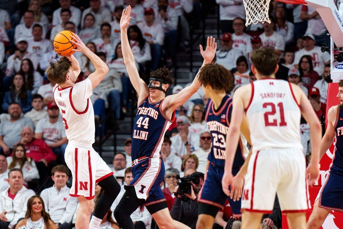 Feb 1, 2026; Lincoln, Nebraska, USA; Nebraska Cornhuskers forward Braden Frager (5) shoots the ball against Illinois Fighting Illini center Zvonimir Ivisic (44) and guard Keaton Wagler (23) during the second half at Pinnacle Bank Arena. Mandatory Credit: Dylan Widger-Imagn Images