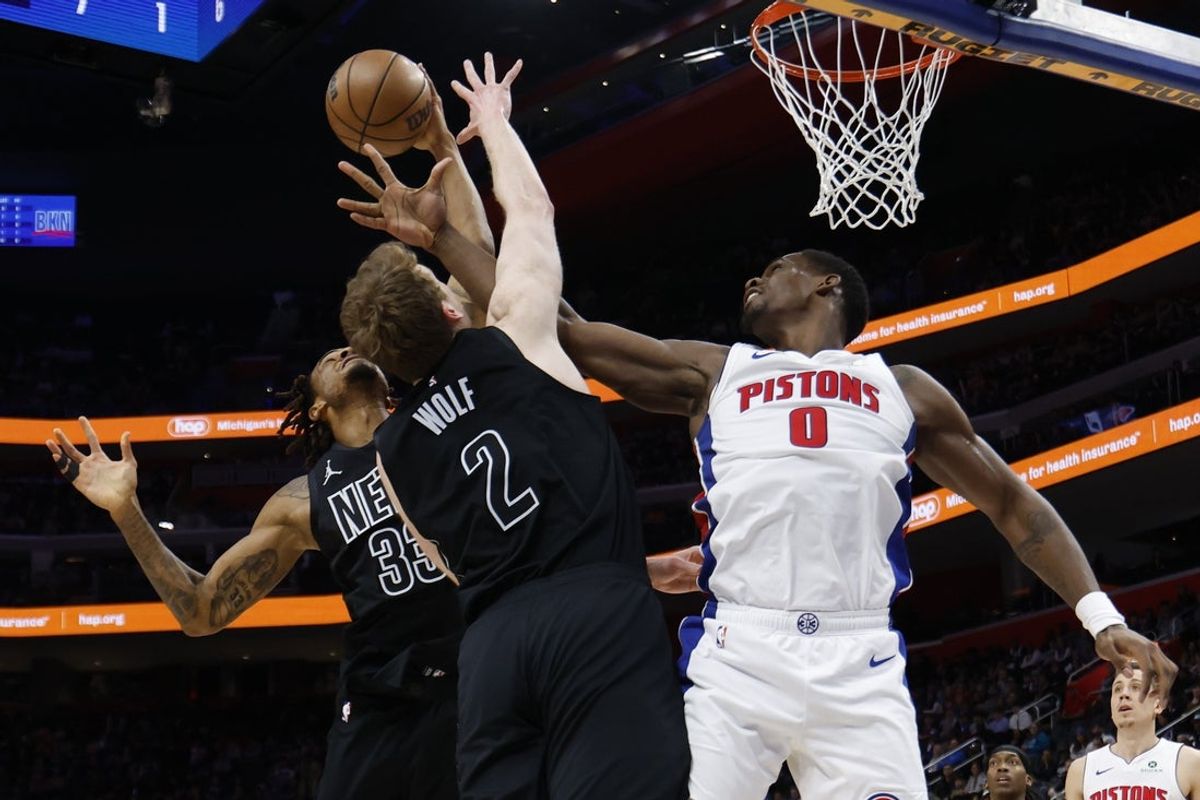 Feb 1, 2026; Detroit, Michigan, USA;  Brooklyn Nets center Nic Claxton (33) forward Danny Wolf (2) and Detroit Pistons center Jalen Duren (0) goes for the rebound in the first half at Little Caesars Arena. Mandatory Credit: Rick Osentoski-Imagn Images