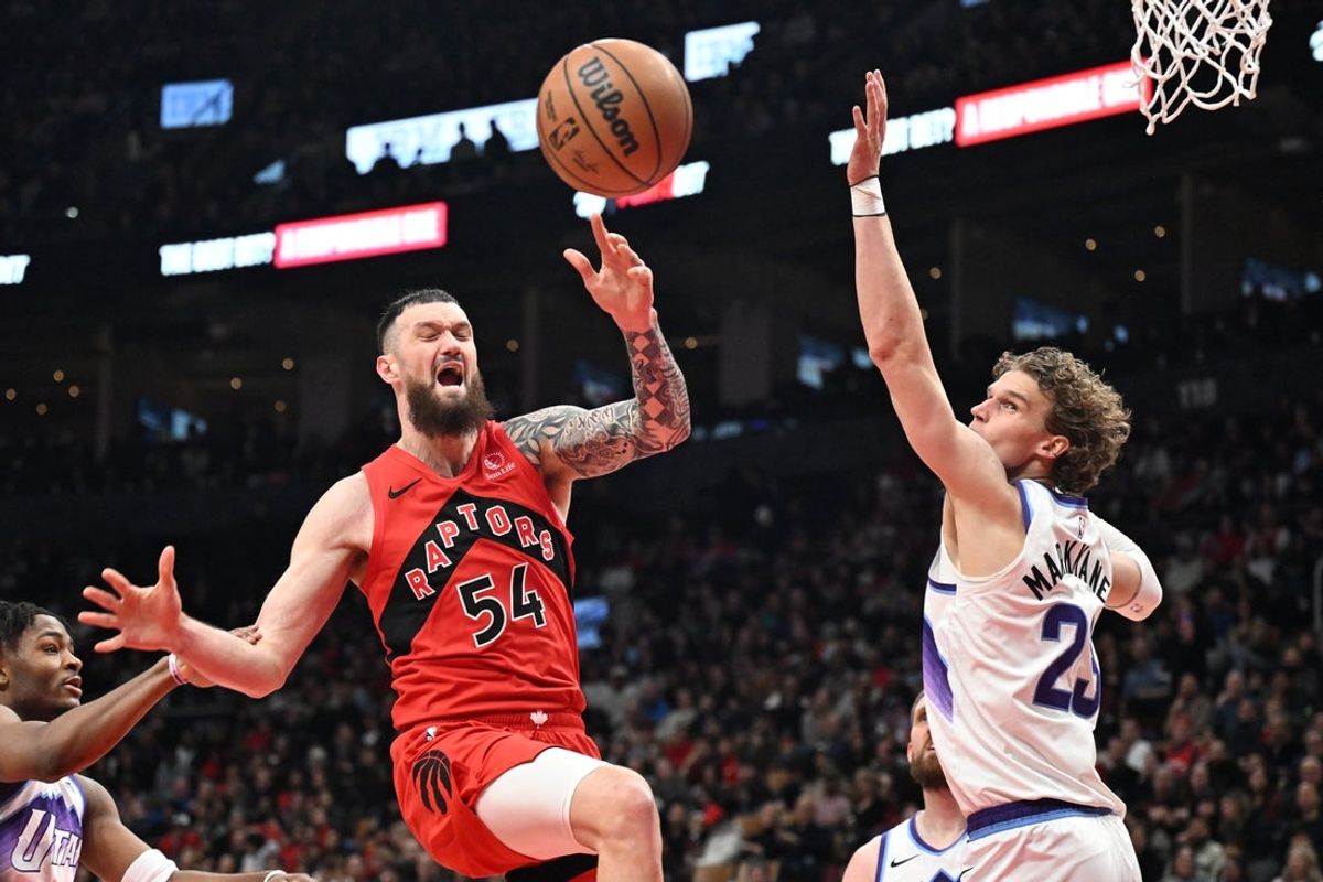Feb 1, 2026; Toronto, Ontario, CAN; Toronto Raptors forward Sandro Mamukelashvili (54) is fouled by Utah Jazz forward Lauri Markkanen (23) in the first half at Scotiabank Arena. Mandatory Credit: Dan Hamilton-Imagn Images