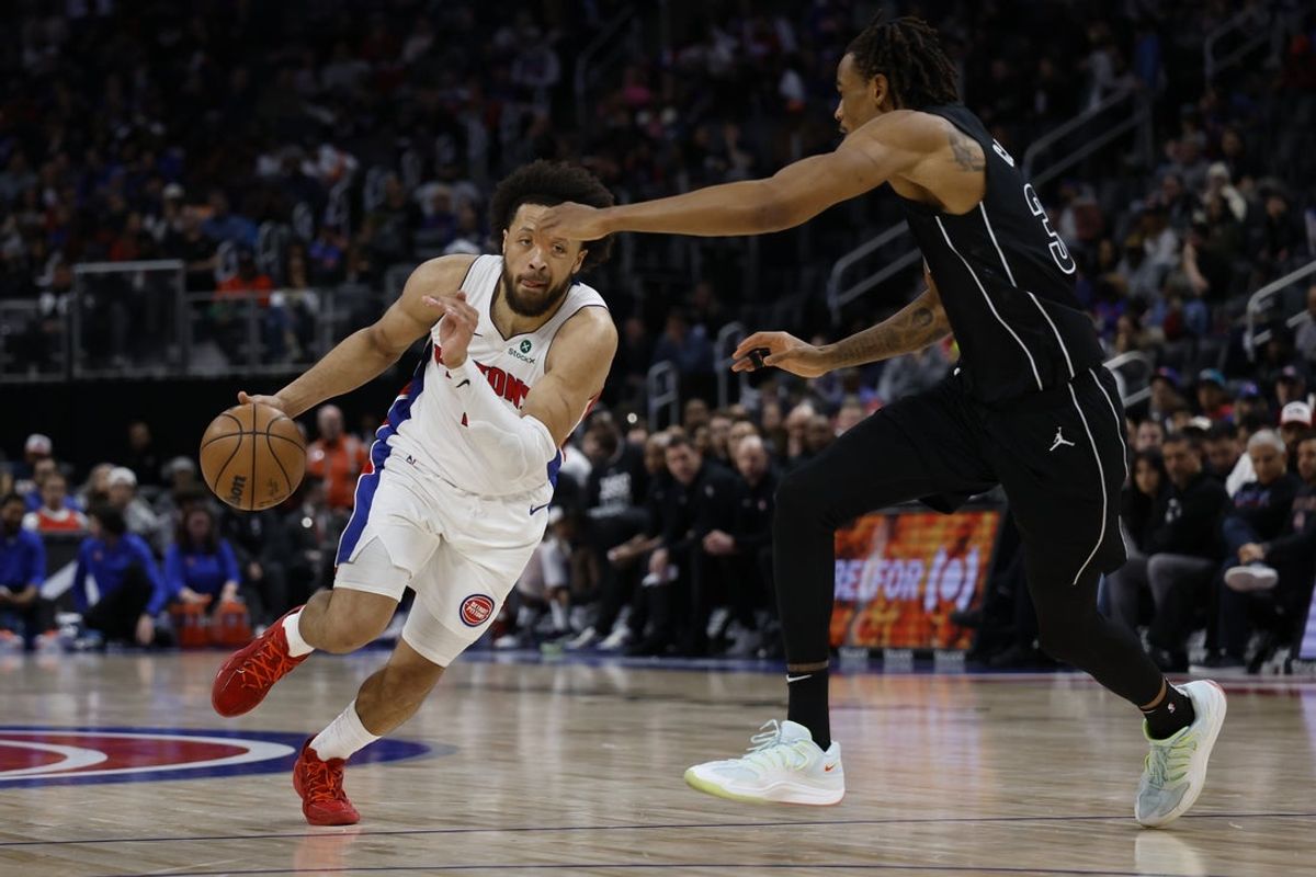 Feb 1, 2026; Detroit, Michigan, USA;  Detroit Pistons guard Cade Cunningham (2) dribbles defended by Brooklyn Nets center Nic Claxton (33) in the second half at Little Caesars Arena. Mandatory Credit: Rick Osentoski-Imagn Images