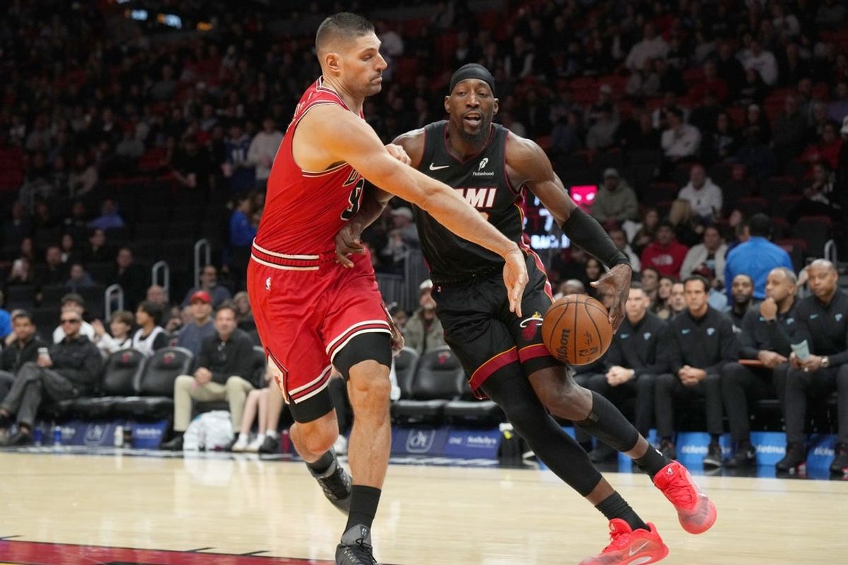 Feb 1, 2026; Miami, Florida, USA;  Miami Heat center Bam Adebayo (13) drives to the basket as Chicago Bulls center Nikola Vucevic (9) defends during the second half at Kaseya Center. Mandatory Credit: Jim Rassol-Imagn Images