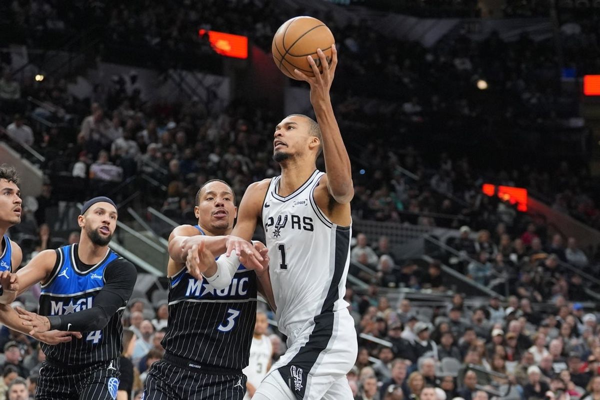 Feb 1, 2026; San Antonio, Texas, USA;  San Antonio Spurs forward Victor Wembanyama (1) is fouled by Orlando Magic guard Desmond Bane (3) in the first half at Frost Bank Center. Mandatory Credit: Daniel Dunn-Imagn Images