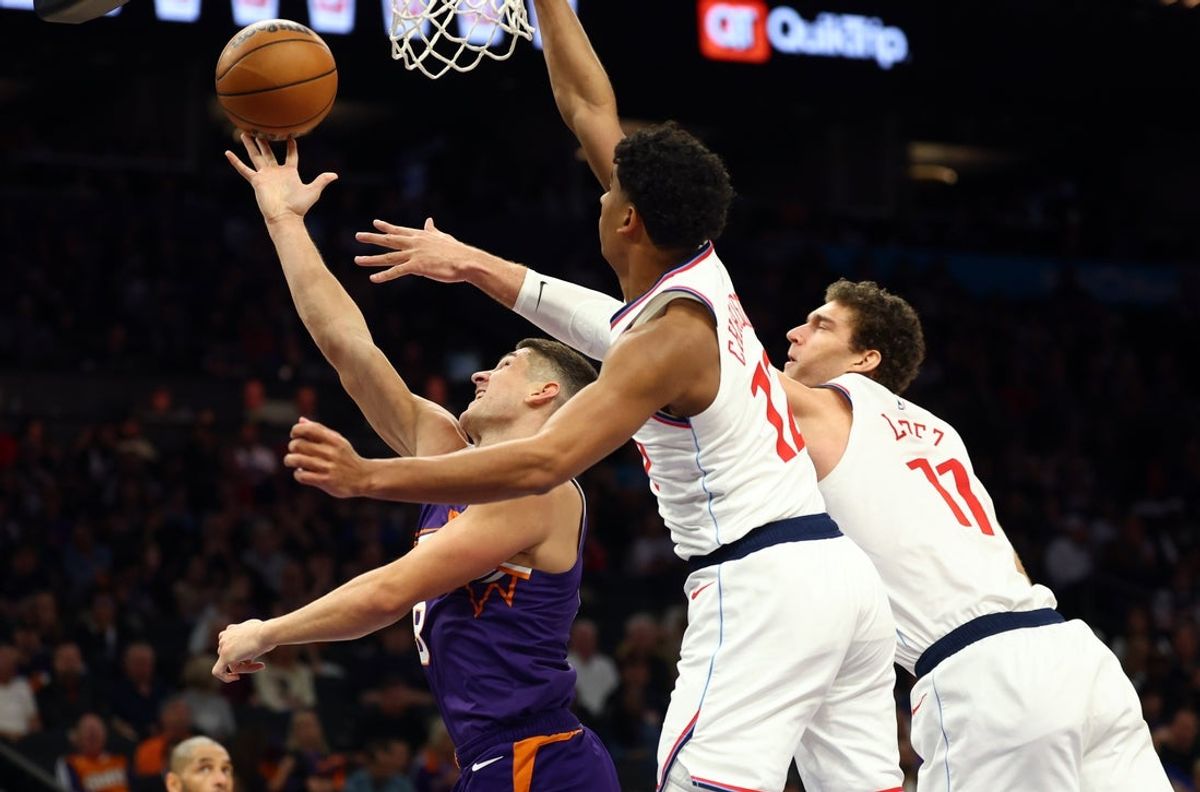 Feb 1, 2026; Phoenix, Arizona, USA; Phoenix Suns guard Grayson Allen (8) drives to the basket against Los Angeles Clippers guard Cam Christie (12) and center Brook Lopez (11) in the second half at Mortgage Matchup Center. Mandatory Credit: Mark J. Rebilas-Imagn Images