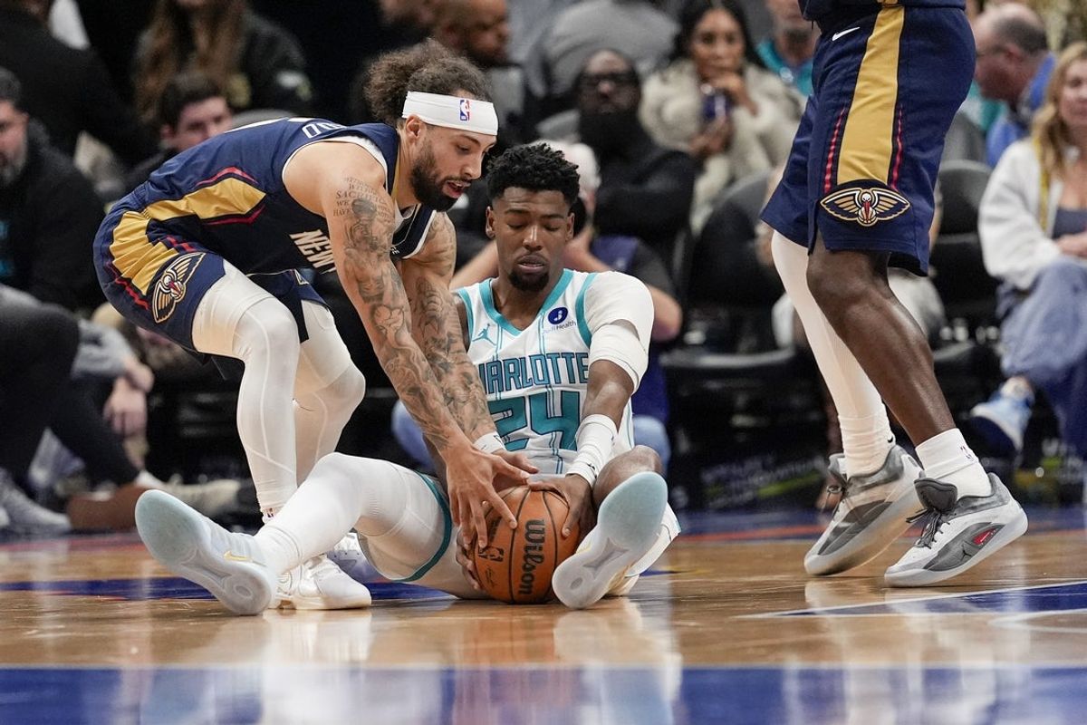Feb 2, 2026; Charlotte, North Carolina, USA; Charlotte Hornets forward Brandon Miller (24) and New Orleans Pelicans guard Jose Alvarado (15) scramble for the loose ball  during the second quarter at the Spectrum Center. Mandatory Credit: Jim Dedmon-Imagn Images
