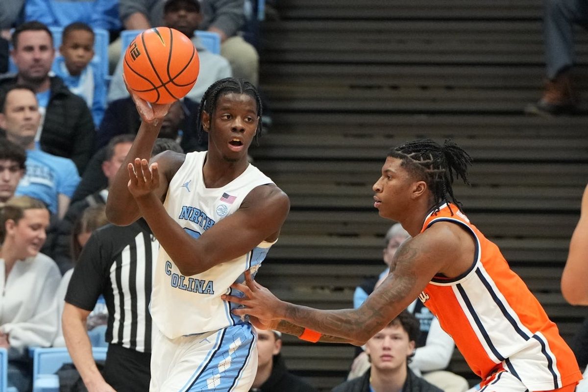 Feb 2, 2026; Chapel Hill, North Carolina, USA;  North Carolina Tar Heels forward Caleb Wilson (8) passes the ball as Syracuse Orange forward Donnie Freeman (1) defends in the first half at Dean E. Smith Center. Mandatory Credit: Bob Donnan-Imagn Images