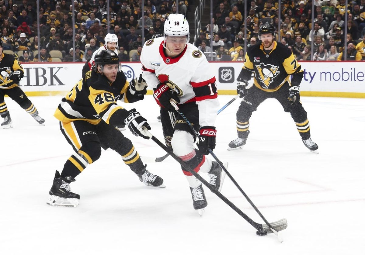 Feb 2, 2026; Pittsburgh, Pennsylvania, USA;  Ottawa Senators center Tim Stutzle (18) handles the puck as Pittsburgh Penguins center Blake Lizotte (46) defends during the second period at PPG Paints Arena. Mandatory Credit: Charles LeClaire-Imagn Images