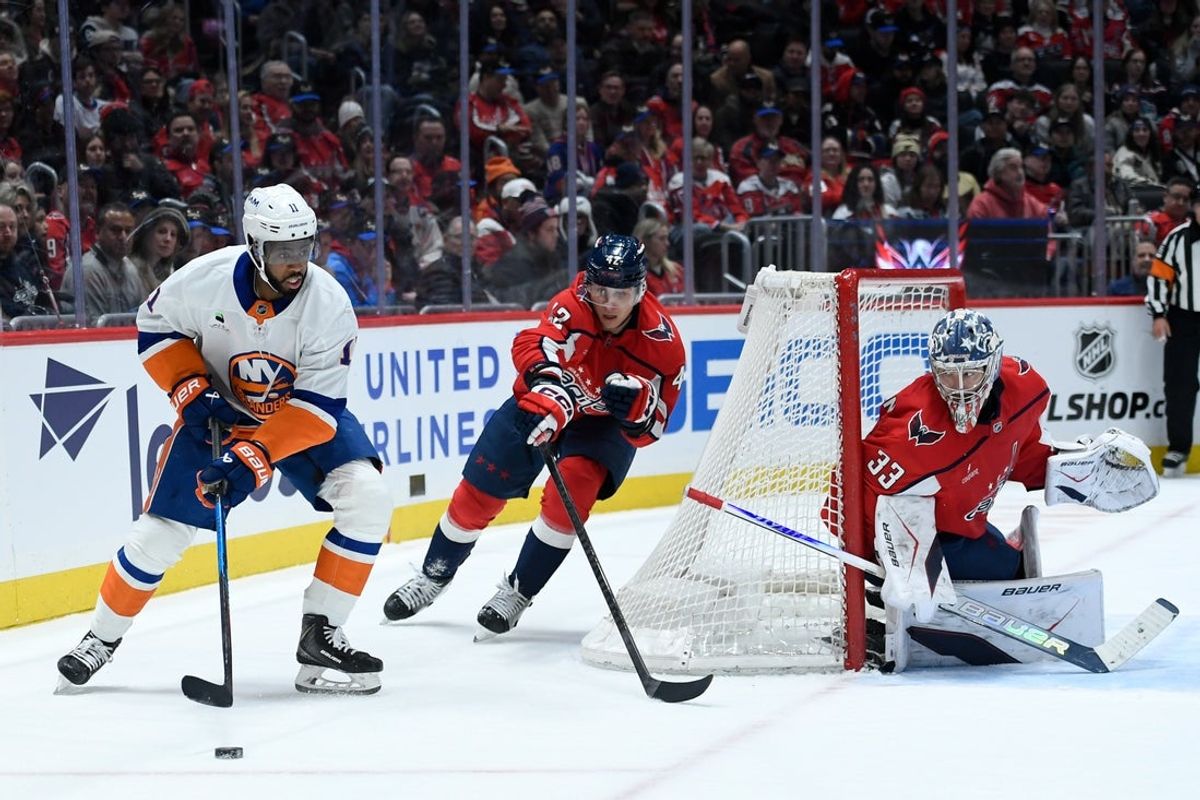 Feb 2, 2026; Washington, District of Columbia, USA; New York Islanders left wing Anthony Duclair (11) controls the puck defended by Washington Capitals defenseman Martin Fehervary (42) during the second period at Capital One Arena. Mandatory Credit: Hannah Foslien-Imagn Images