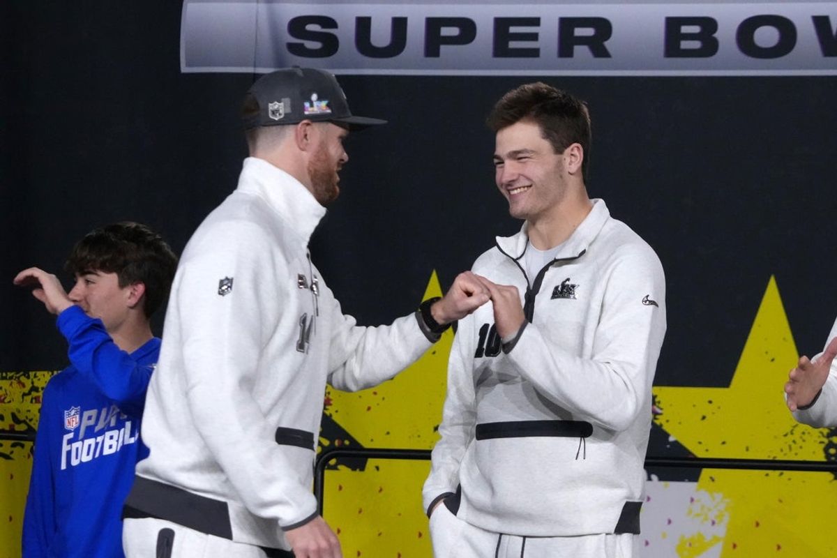 Feb 2, 2026; San Jose, CA, USA; Seattle Seahawks quarterback Sam Darnold (14) and New England Patriots quarterback Drake Maye (10) shake hands during Opening Night for Super Bowl LX at San Jose Convention Center. Mandatory Credit: Kirby Lee-Imagn Images
