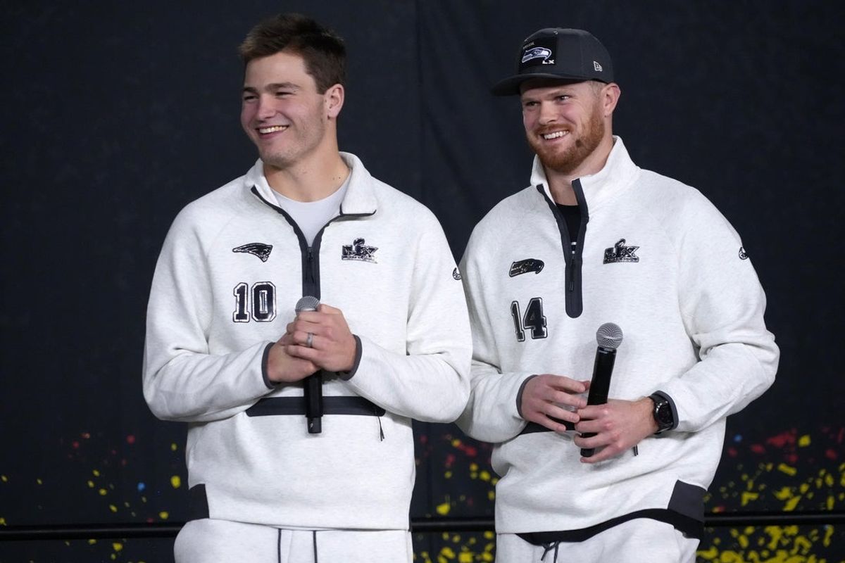 Feb 2, 2026; San Jose, CA, USA; Seattle Seahawks quarterback Sam Darnold (14) and New England Patriots quarterback Drake Maye (10) during Opening Night for Super Bowl LX at San Jose Convention Center. Mandatory Credit: Kirby Lee-Imagn Images