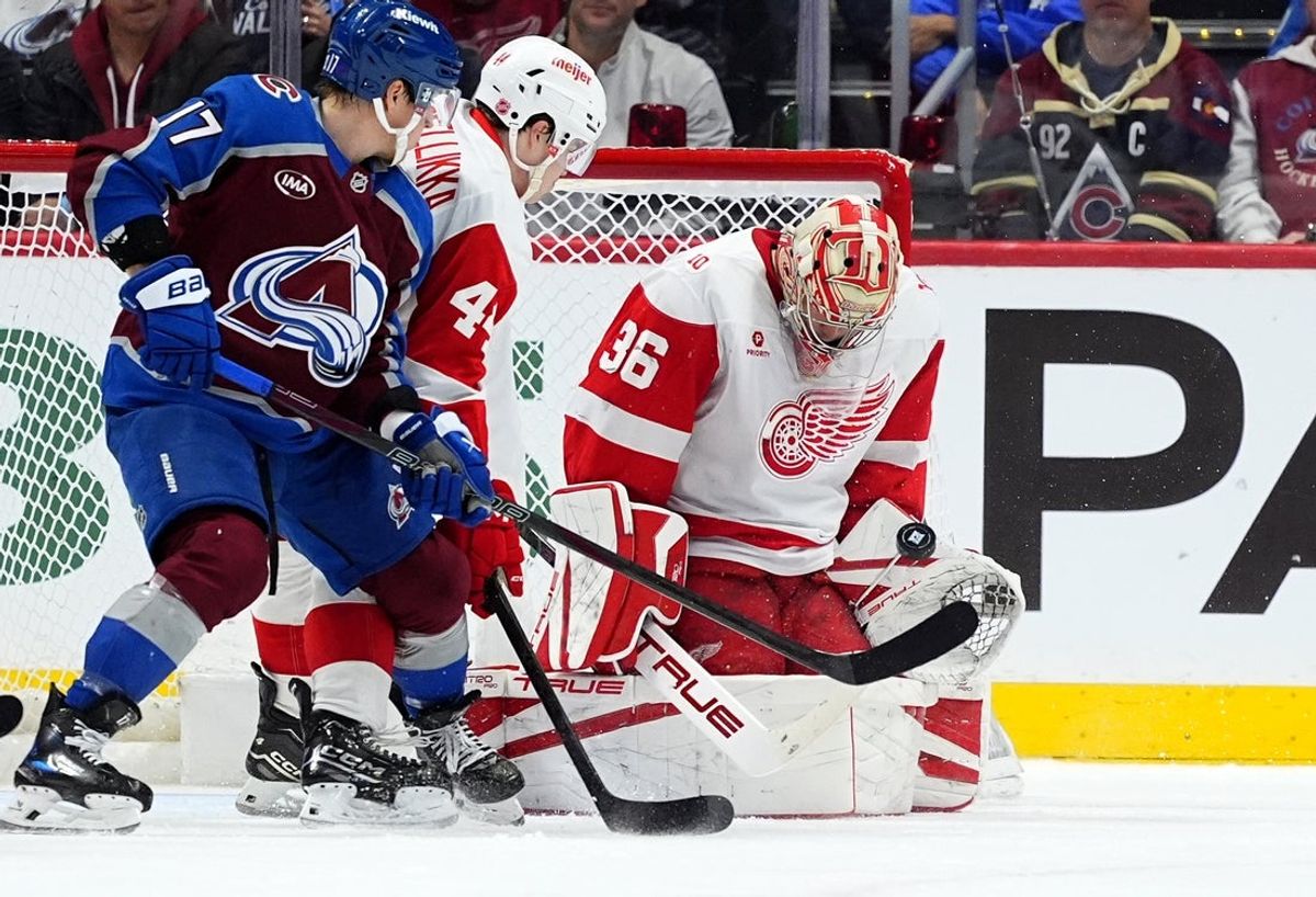 Feb 2, 2026; Denver, Colorado, USA; Detroit Red Wings goaltender John Gibson (36) makes a save next to defenseman Axel Sandin-Pellikka (44) and Colorado Avalanche center Parker Kelly (17) in the first period at Ball Arena. Mandatory Credit: Ron Chenoy-Imagn Images