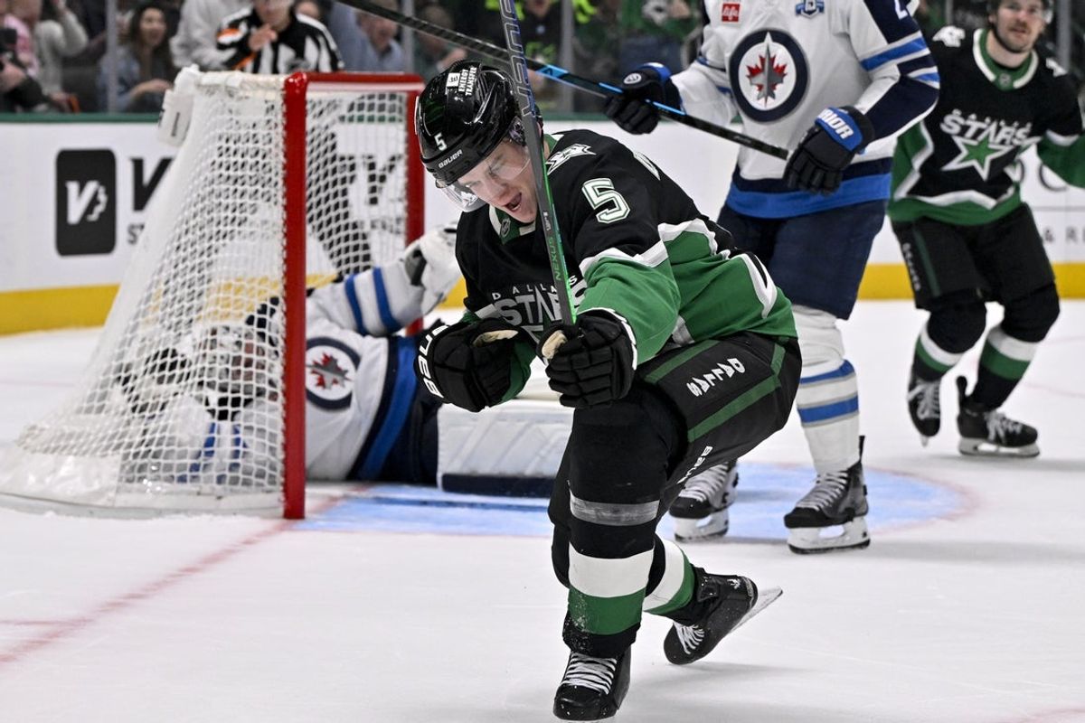 Feb 2, 2026; Dallas, Texas, USA; Dallas Stars defenseman Nils Lundkvist (5) celebrates after he scores a goal against Winnipeg Jets goaltender Connor Hellebuyck (37) during the second period at the American Airlines Center. Mandatory Credit: Jerome Miron-Imagn Images