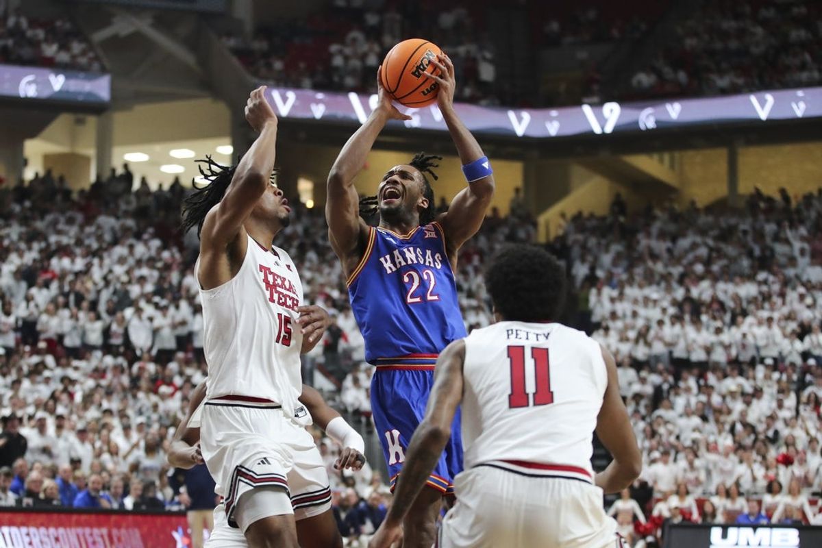 Feb 2, 2026; Lubbock, Texas, USA;  Kansas Jayhawks guard Darryn Peterson (22) goes to the basket against Texas Tech Red Raiders forward JT Toppin (15) in the first half at United Supermarkets Arena. Mandatory Credit: Michael C. Johnson-Imagn Images