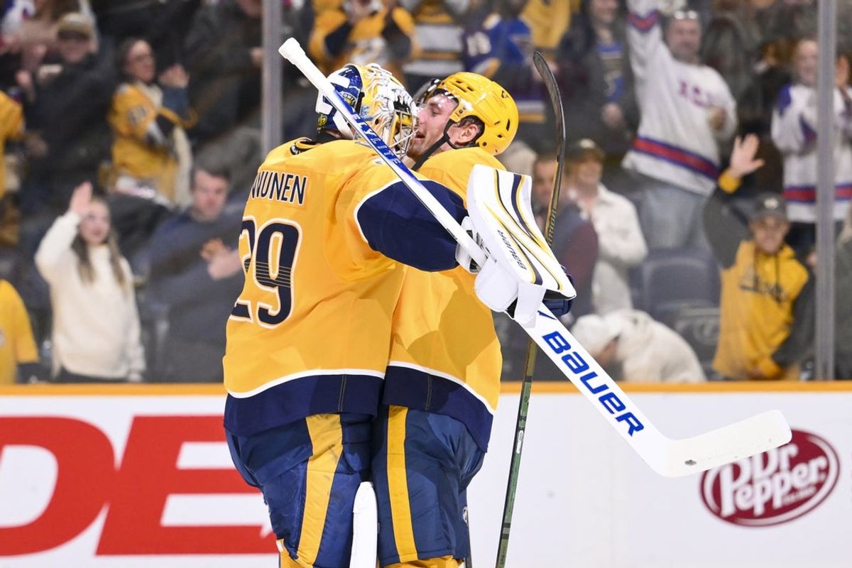Feb 2, 2026; Nashville, Tennessee, USA;  Nashville Predators center Ryan O'Reilly (90) celebrates the win with goaltender Justus Annunen (29) against the St. Louis Blues during the third period at Bridgestone Arena. Mandatory Credit: Steve Roberts-Imagn Images
