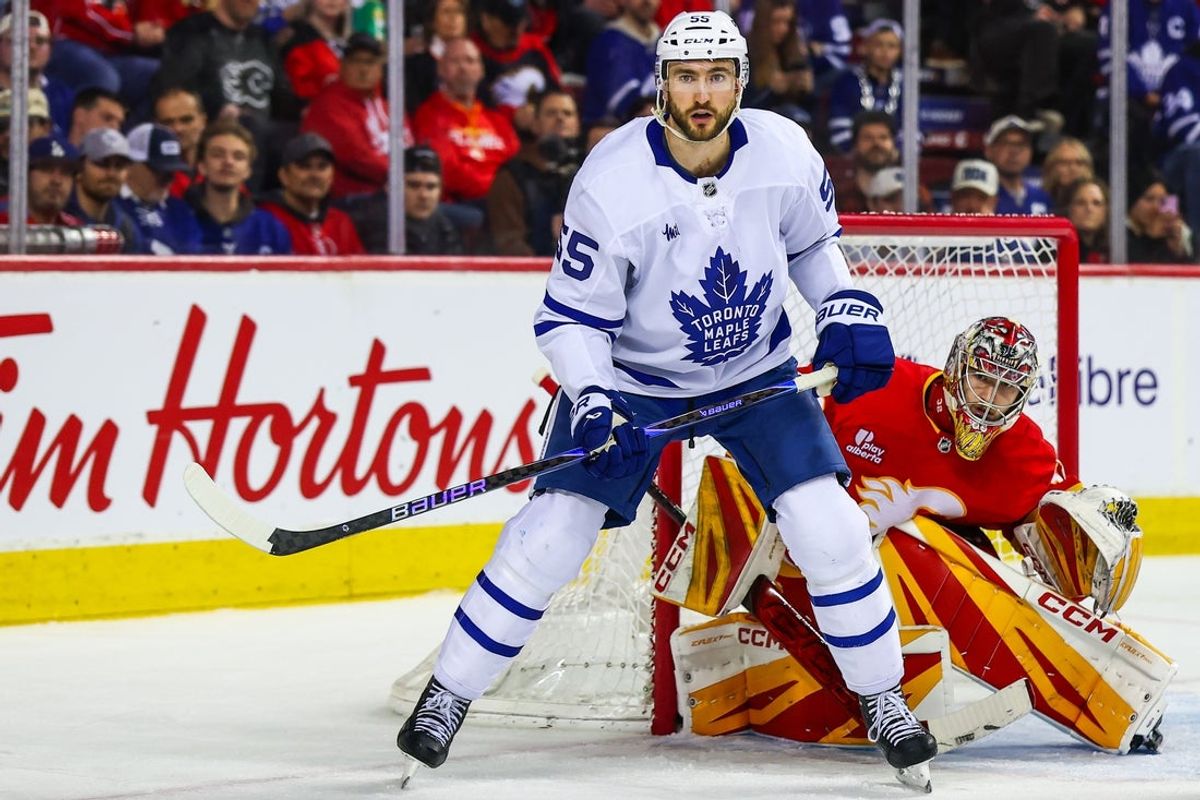 Feb 2, 2026; Calgary, Alberta, CAN; Toronto Maple Leafs center Nicolas Roy (55) screens in front of Calgary Flames goaltender Dustin Wolf (32) during the third period at Scotiabank Saddledome. Mandatory Credit: Sergei Belski-Imagn Images