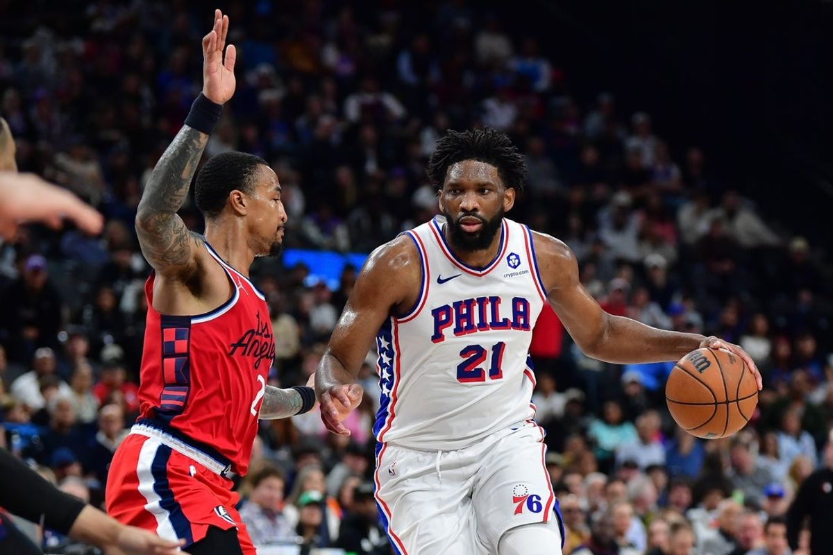 Feb 2, 2026; Inglewood, California, USA; Philadelphia 76ers center Joel Embiid (21) moves the ball against Los Angeles Clippers forward John Collins (20) during the second half at Intuit Dome. Mandatory Credit: Gary A. Vasquez-Imagn Images