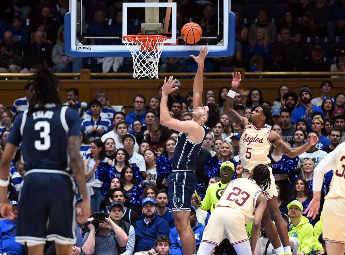 Feb 3, 2026; Durham, North Carolina, USA;  Duke Blue Devils forward Cameron Boozer (12) lays the ball up in front of Boston College Eagles guard Fred Payne (5) during the first half at Cameron Indoor Stadium. Mandatory Credit: Rob Kinnan-Imagn Images