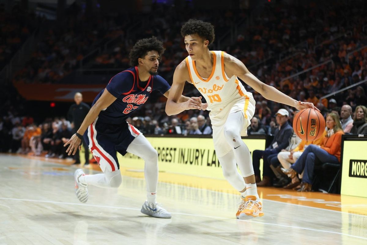 Feb 3, 2026; Knoxville, Tennessee, USA;  Tennessee Volunteers forward Nate Ament (10) moves the ball against Mississippi Rebels guard Patton Pinkins (23) during the first half at Thompson-Boling Arena at Food City Center. Mandatory Credit: Randy Sartin-Imagn Images