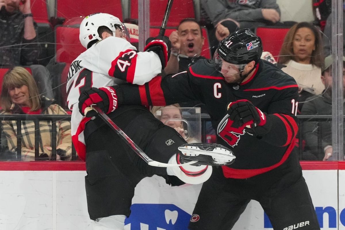 Feb 3, 2026; Raleigh, North Carolina, USA;  Carolina Hurricanes center Jordan Staal (11) checks Ottawa Senators defenseman Tyler Kleven (43) during the first period at Lenovo Center. Mandatory Credit: James Guillory-Imagn Images