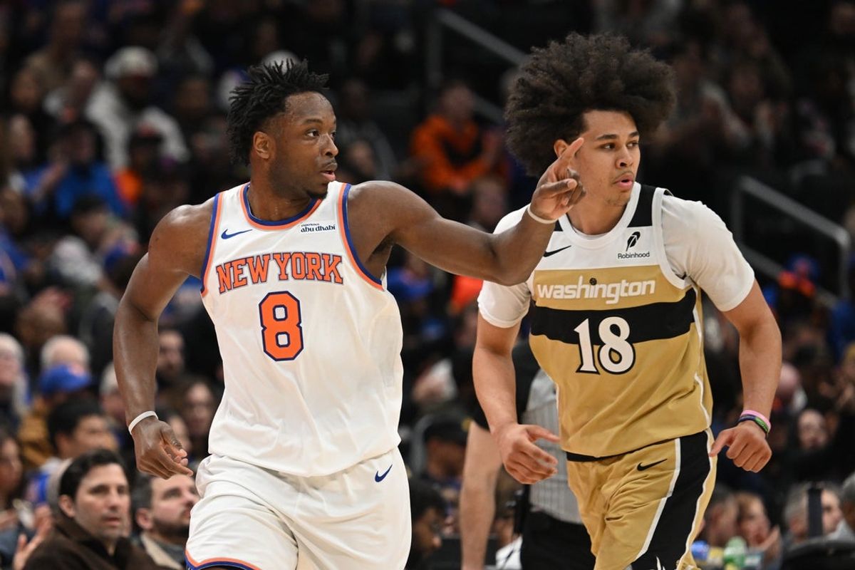 Feb 3, 2026; Washington, District of Columbia, USA; New York Knicks forward OG Anunoby (8) reacts after making a three point basket in front of Washington Wizards forward Kyshawn George (18) during the first quarter at Capital One Arena. Mandatory Credit: Rafael Suanes-Imagn Images