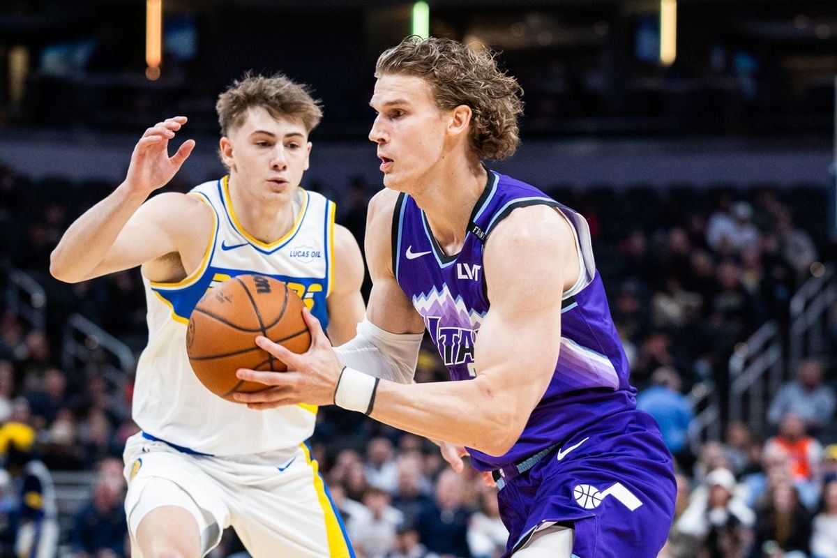 Feb 3, 2026; Indianapolis, Indiana, USA; Utah Jazz forward/center Lauri Markkanen (23) dribbles the ball while Indiana Pacers guard Johnny Furphy (12) defends in the first half at Gainbridge Fieldhouse. Mandatory Credit: Trevor Ruszkowski-Imagn Images