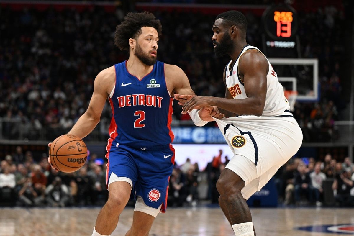 Feb 3, 2026; Detroit, Michigan, USA;  Detroit Pistons guard Cade Cunningham (2) tugs on the shorts of Denver Nuggets guard Tim Hardaway Jr. (10) before trying to drive past him in the second quarter at Little Caesars Arena. Mandatory Credit: Lon Horwedel-Imagn Images