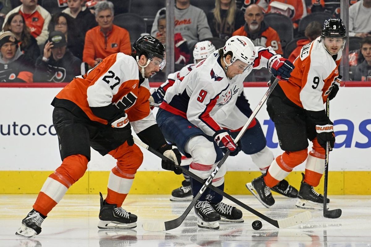 Feb 3, 2026; Philadelphia, Pennsylvania, USA; Washington Capitals right wing Ryan Leonard (9) and Philadelphia Flyers left wing Noah Cates (27) battle for the puck during the second period at Xfinity Mobile Arena. Mandatory Credit: Eric Hartline-Imagn Images