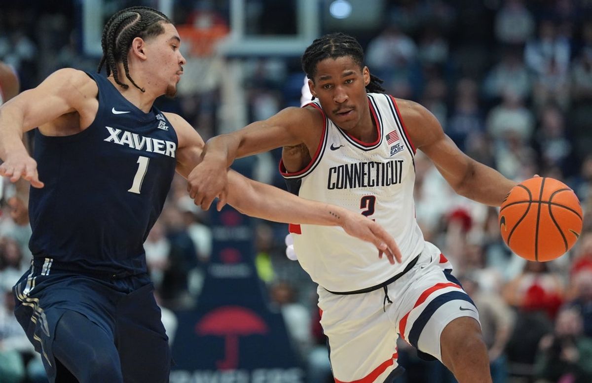 Feb 3, 2026; Hartford, Connecticut, USA; UConn Huskies guard Silas Demary Jr. (2) drives the ball against Xavier Musketeers guard Malik Messina-Moore (1) in the second half at PeoplesBank Arena. Mandatory Credit: David Butler II-Imagn Images
