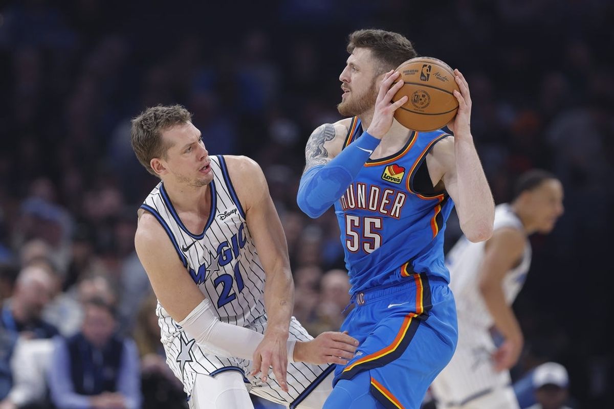 Feb 3, 2026; Oklahoma City, Oklahoma, USA; Oklahoma City Thunder center/forward Isaiah Hartenstein (55) moves the ball as Orlando Magic forward/center Moritz Wagner (21) defends during the second quarter at Paycom Center. Mandatory Credit: Alonzo Adams-Imagn Images
