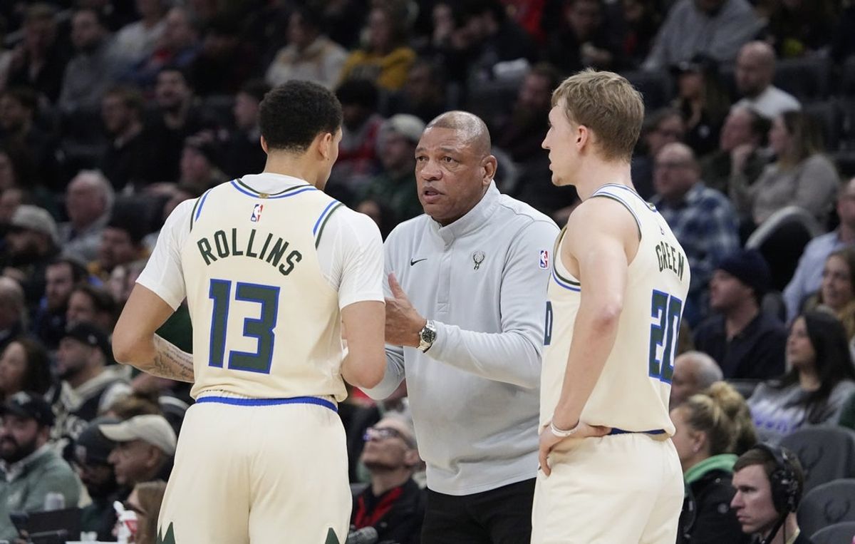 Feb 3, 2026; Milwaukee, Wisconsin, USA; Milwaukee Bucks head coach Doc Rivers talks with guard Ryan Rollins (13) and guard AJ Green (20) during a time out against the Chicago Bulls at Fiserv Forum. Mandatory Credit: Michael McLoone-Imagn Images