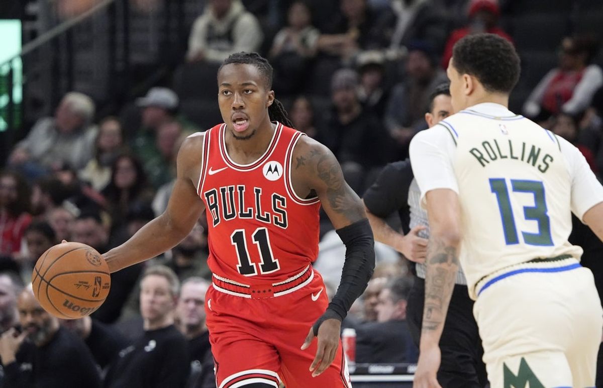Feb 3, 2026; Milwaukee, Wisconsin, USA; Chicago Bulls guard Ayo Dosunmu (11) dribbles the ball against Milwaukee Bucks guard Ryan Rollins (13) in the first half at Fiserv Forum. Mandatory Credit: Michael McLoone-Imagn Images