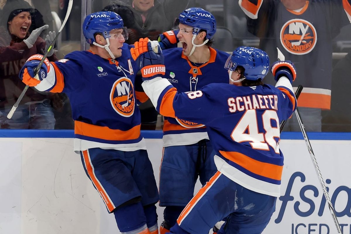 Feb 3, 2026; Elmont, New York, USA; New York Islanders center Bo Horvat (14) celebrates his game winning overtime goal against the Pittsburgh Penguins with center Mathew Barzal (13) and defenseman Matthew Schaefer (48) at UBS Arena. Mandatory Credit: Brad Penner-Imagn Images