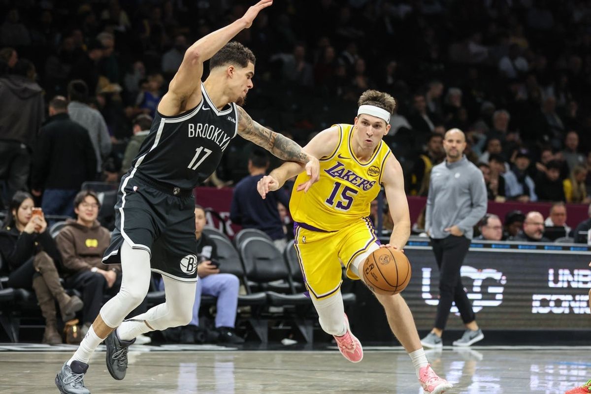 Feb 3, 2026; Brooklyn, New York, USA;  Los Angeles Lakers guard Austin Reaves (15) looks to drive past Brooklyn Nets forward Michael Porter Jr. (17) in the third quarter at Barclays Center. Mandatory Credit: Wendell Cruz-Imagn Images
