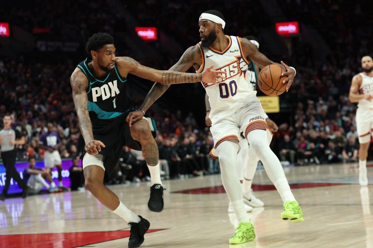 Feb 3, 2026; Portland, Oregon, USA;  Phoenix Suns forward Royce O'Neale (00) drives to the basket past Portland Trail Blazers guard Blake Wesley (1) during the second half at Moda Center. Mandatory Credit: Jaime Valdez-Imagn Images