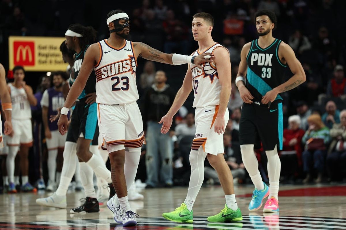 Feb 3, 2026; Portland, Oregon, USA;  Phoenix Suns guard Jordan Goodwin (23) recognizes teammate guard Collin Gillespie (12) during the second half against the Portland Trail Blazers at Moda Center. Mandatory Credit: Jaime Valdez-Imagn Images