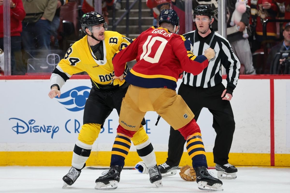 Feb 4, 2026; Sunrise, Florida, USA; Boston Bruins left wing Tanner Jeannot (84) and Florida Panthers left wing A.J. Greer (10) fight during the first period at Amerant Bank Arena. Mandatory Credit: Sam Navarro-Imagn Images