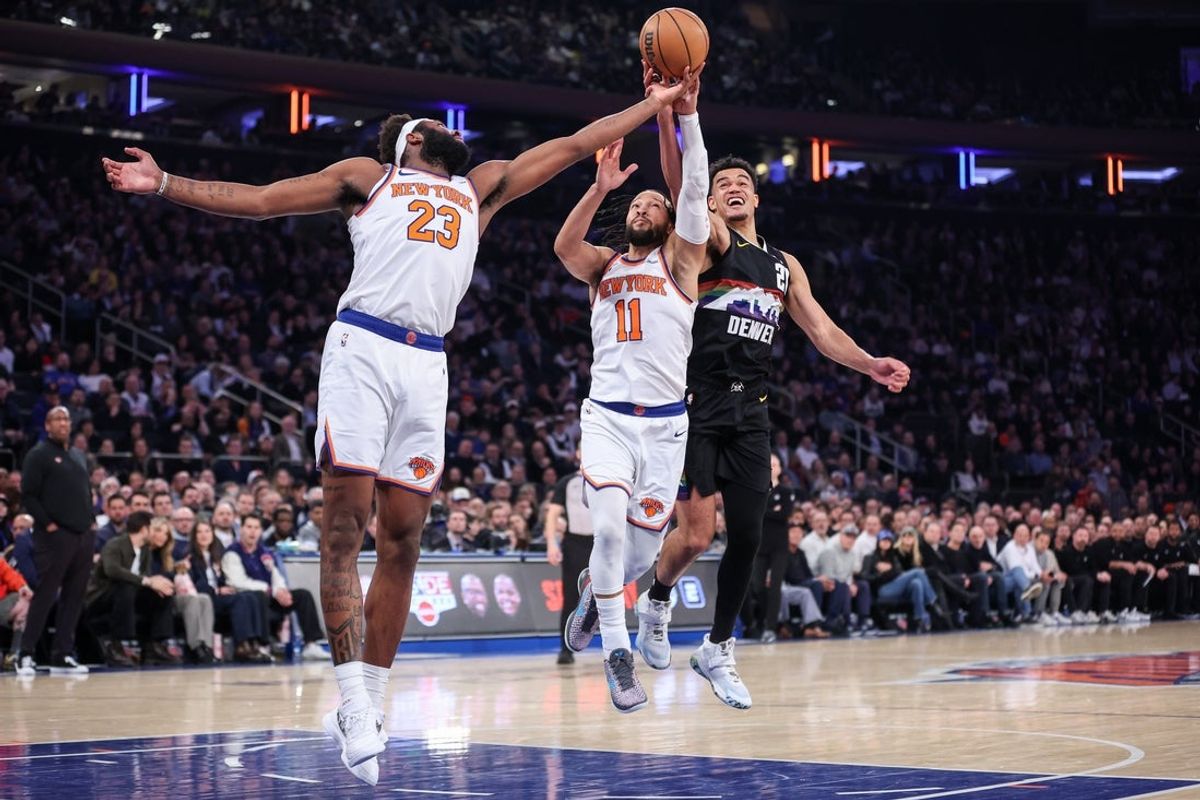 Feb 4, 2026; New York, New York, USA;  Denver Nuggets forward Spencer Jones (21) fights for a loose ball with New York Knicks center Mitchell Robinson (23) and guard Jalen Brunson (11) in the first quarter at Madison Square Garden. Mandatory Credit: Wendell Cruz-Imagn Images
