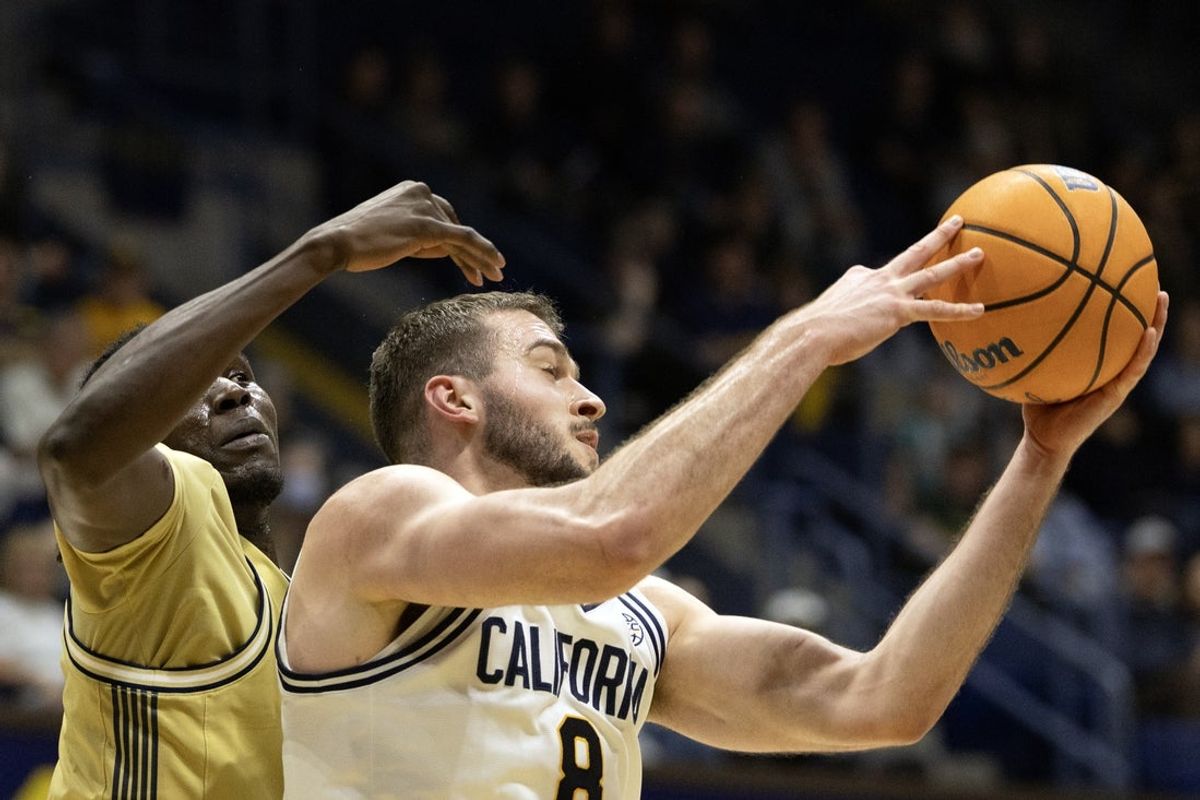 Feb 4, 2026; Berkeley, California, USA; California Golden Bears center Milos Ilic (8) rebounds in front of Georgia Tech Yellow Jackets forward Baye Ndongo (11) during the first half at Haas Pavilion. Mandatory Credit: D. Ross Cameron-Imagn Images