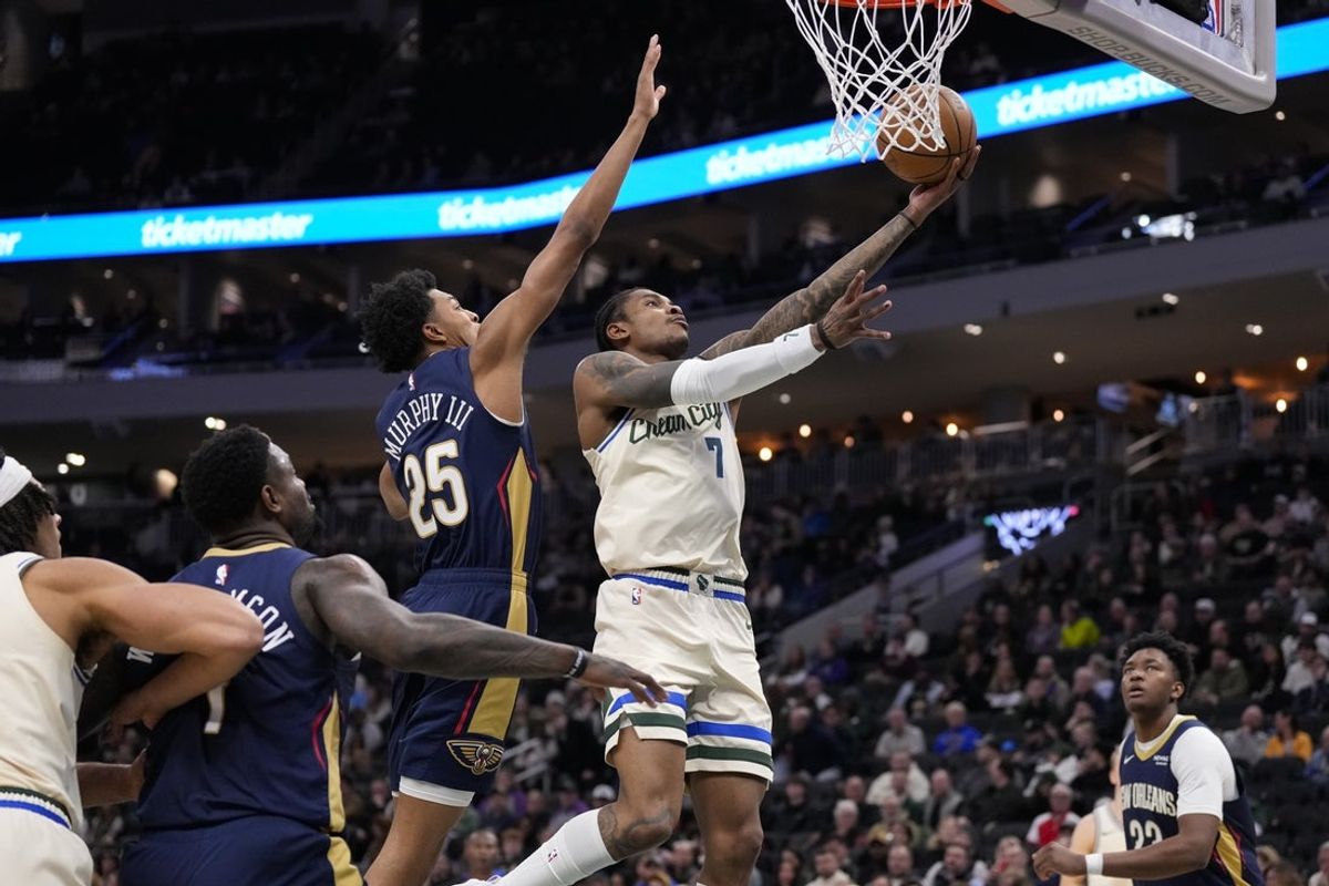 Feb 4, 2026; Milwaukee, Wisconsin, USA;  Milwaukee Bucks guard Kevin Porter Jr. (7) shoots in against New Orleans Pelicans forward Trey Murphy III (25) during the second quarter at Fiserv Forum. Mandatory Credit: Jeff Hanisch-Imagn Images