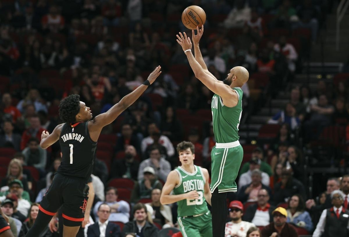 Feb 4, 2026; Houston, Texas, USA; Boston Celtics guard Derrick White (9) shoots the ball as Houston Rockets guard Amen Thompson (1) defends during the second quarter at Toyota Center. Mandatory Credit: Troy Taormina-Imagn Images