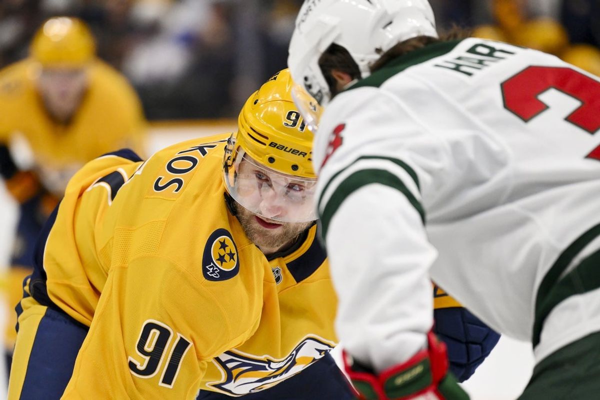 Feb 4, 2026; Nashville, Tennessee, USA;  Nashville Predators center Steven Stamkos (91) and Minnesota Wild right wing Ryan Hartman (38) face off during the first period at Bridgestone Arena. Mandatory Credit: Steve Roberts-Imagn Images