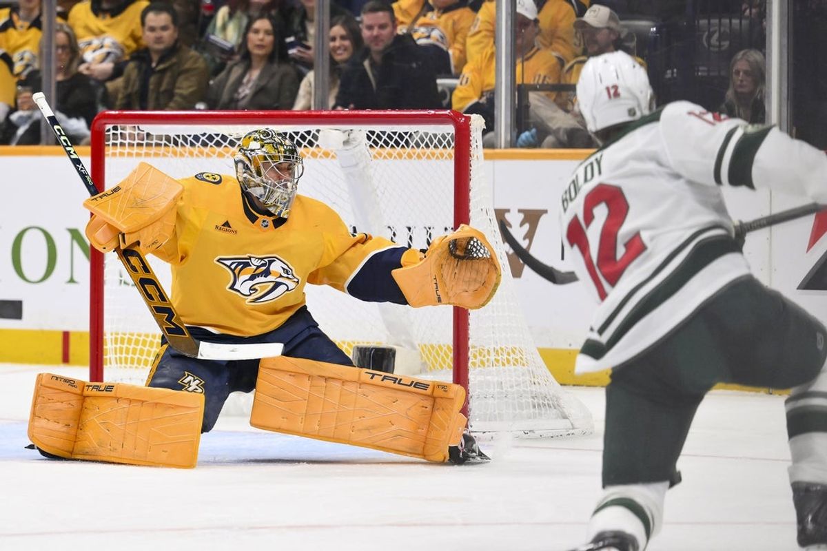 Feb 4, 2026; Nashville, Tennessee, USA;  Nashville Predators goaltender Juuse Saros (74) blocks the shot of Minnesota Wild left wing Matt Boldy (12) during the second period at Bridgestone Arena. Mandatory Credit: Steve Roberts-Imagn Images