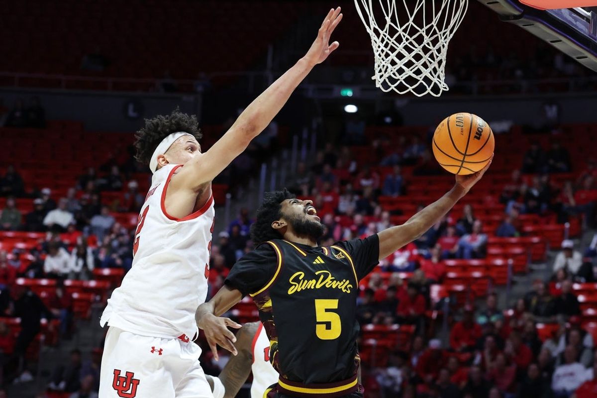 Feb 4, 2026; Salt Lake City, Utah, USA; Arizona State Sun Devils guard Maurice Odum (5) goes to the basket against Utah Utes forward James Okonkwo (32) during the first half at Jon M. Huntsman Center. Mandatory Credit: Rob Gray-Imagn Images