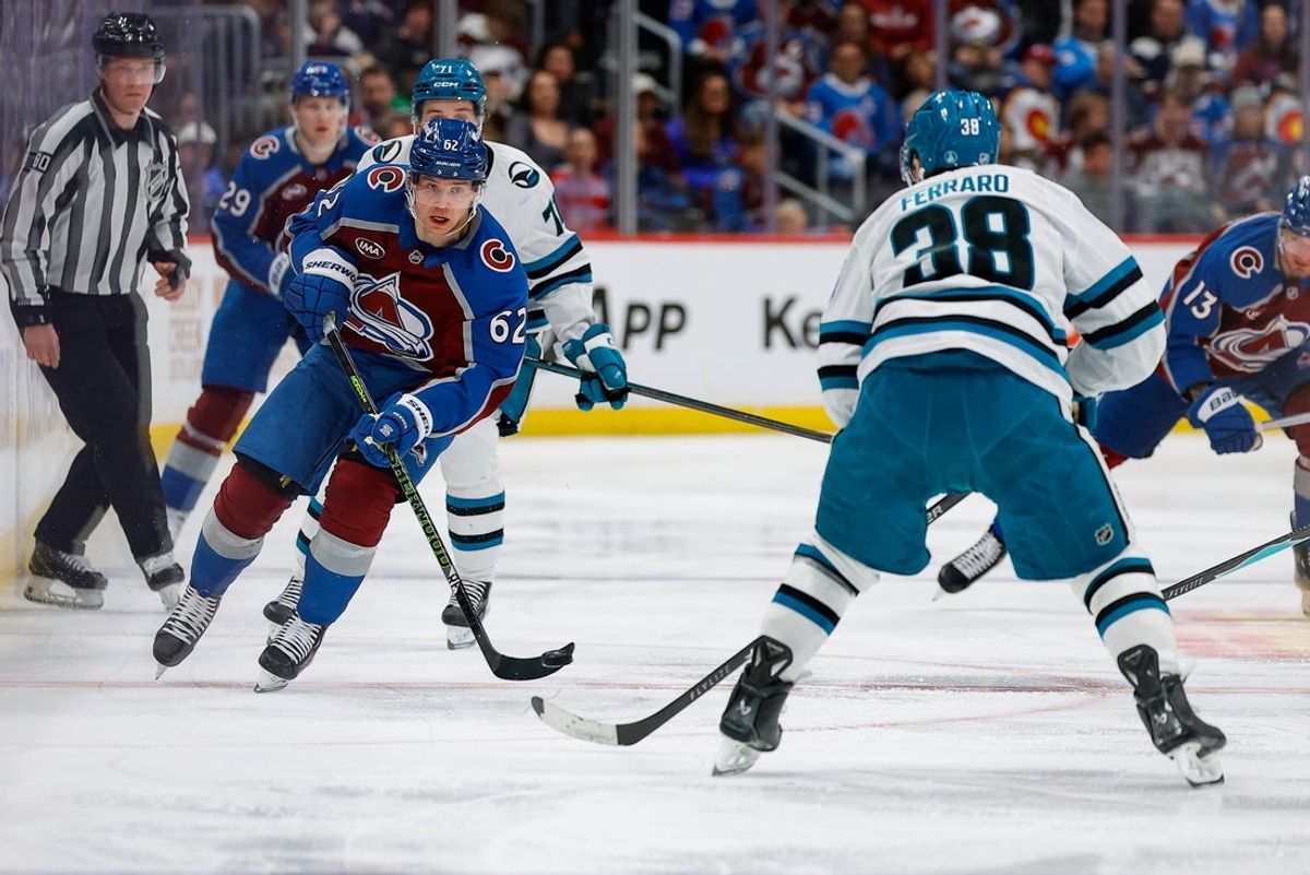 Feb 4, 2026; Denver, Colorado, USA; Colorado Avalanche left wing Artturi Lehkonen (62) plays the puck forward against San Jose Sharks defenseman Mario Ferraro (38) in the second period at Ball Arena. Mandatory Credit: Isaiah J. Downing-Imagn Images