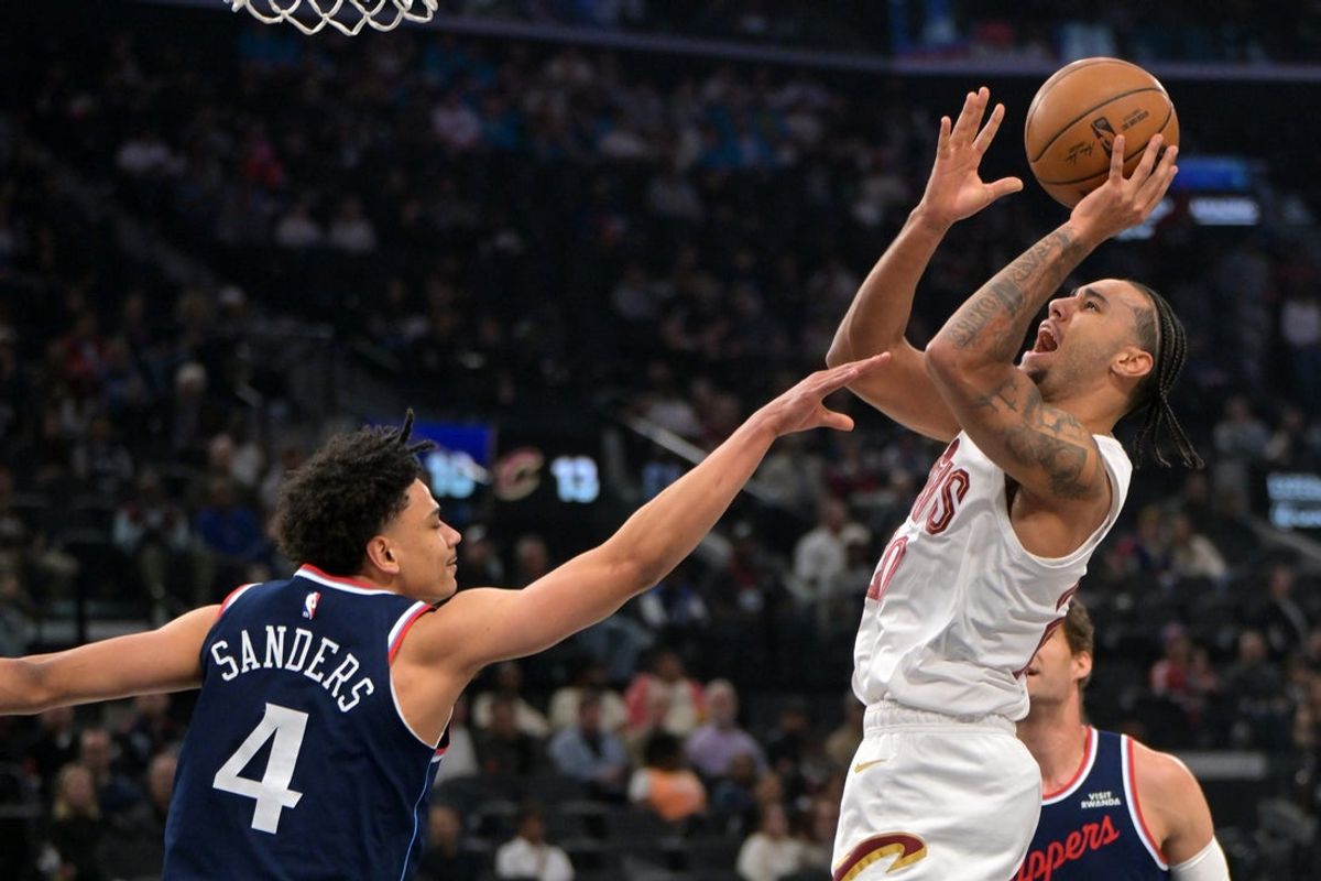 Feb 4, 2026; Inglewood, California, USA; Cleveland Cavaliers guard Jaylon Tyson (20) is defended by Los Angeles Clippers guard Kobe Sanders (4) as he shoots the ball in the first half at Intuit Dome. Mandatory Credit: Jayne Kamin-Oncea-Imagn Images
