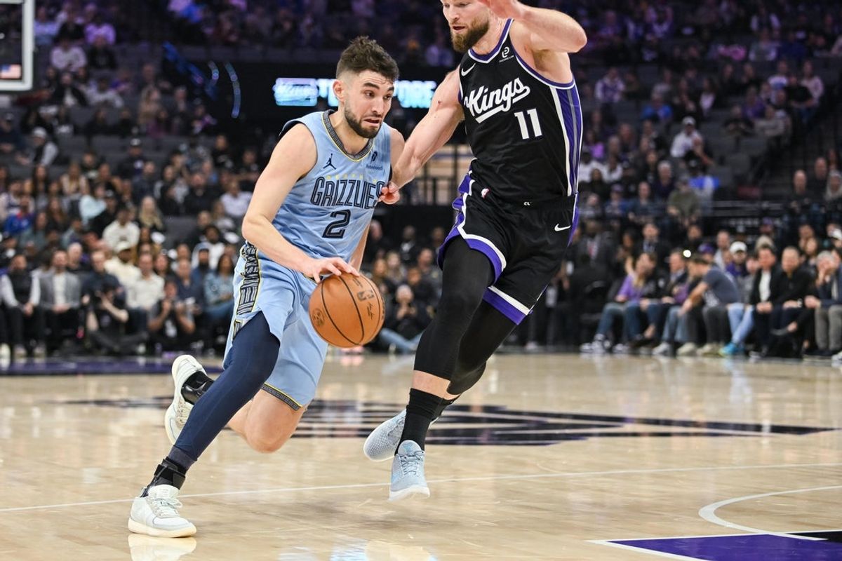 Feb 4, 2026; Sacramento, California, USA; Memphis Grizzlies guard/forward Ty Jerome (2) drives against Sacramento Kings forward/center Domantas Sabonis (11) during the second quarter at Golden 1 Center. Mandatory Credit: Ed Szczepanski-Imagn Images